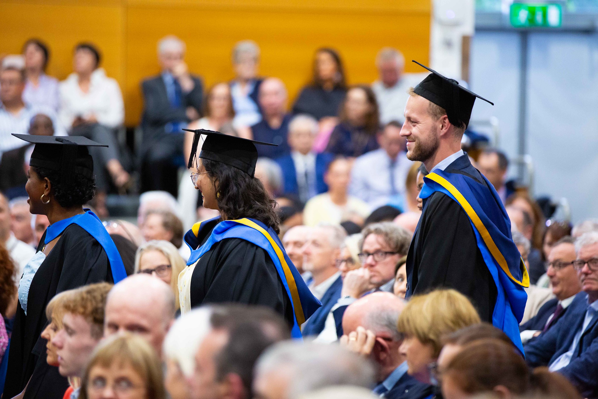Students smiling in a ceremony